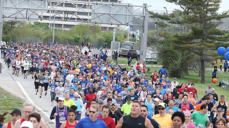 Participants run during the Long Island Marathon on the course in...