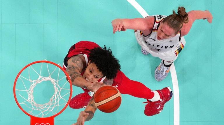 United States' Brittney Griner, left, shoots as Belgium's Emma Meesseman...