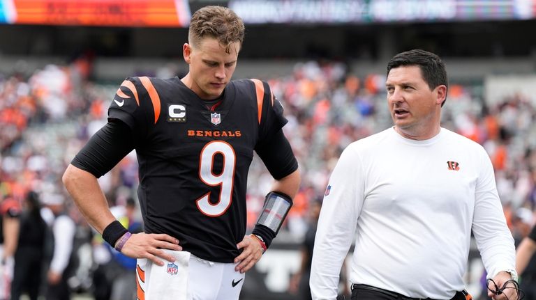 Cincinnati Bengals quarterback Joe Burrow (9) walks off the field...