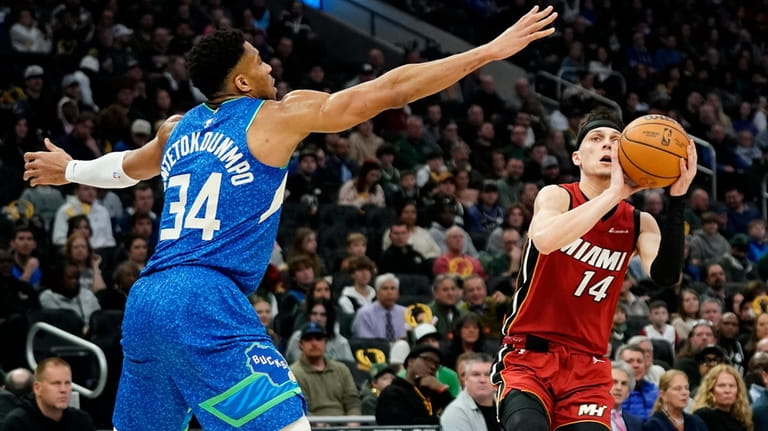 Miami Heat's Tyler Herro (14) drives to the basket against...