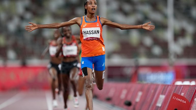 Sifan Hassan, of the Netherlands, celebrates as she crosses the...