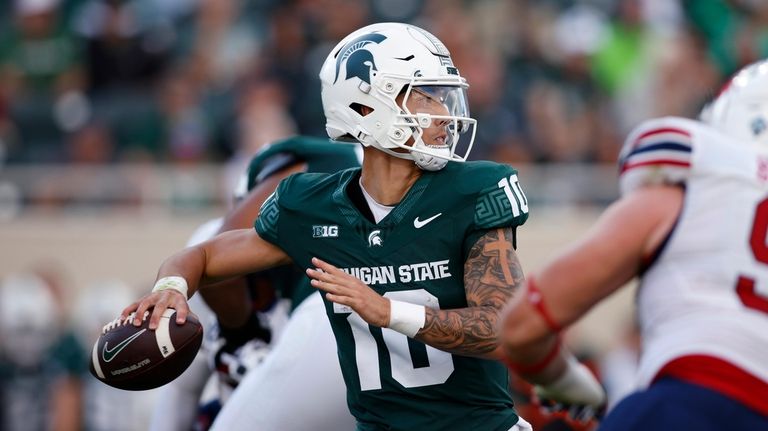 Michigan State quarterback Noah Kim looks for a receiver during...