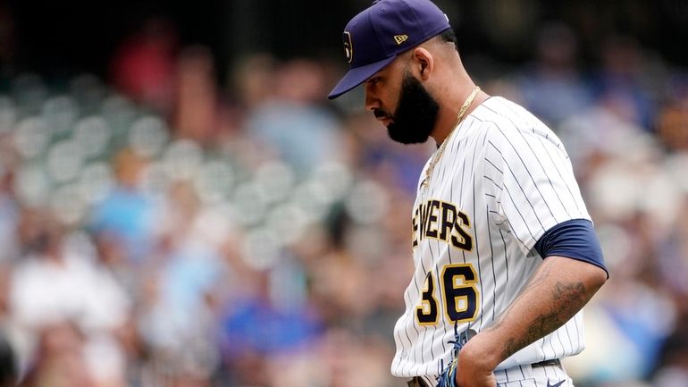 Milwaukee Brewers' J.C. Mejia (36) reacts after giving up a...