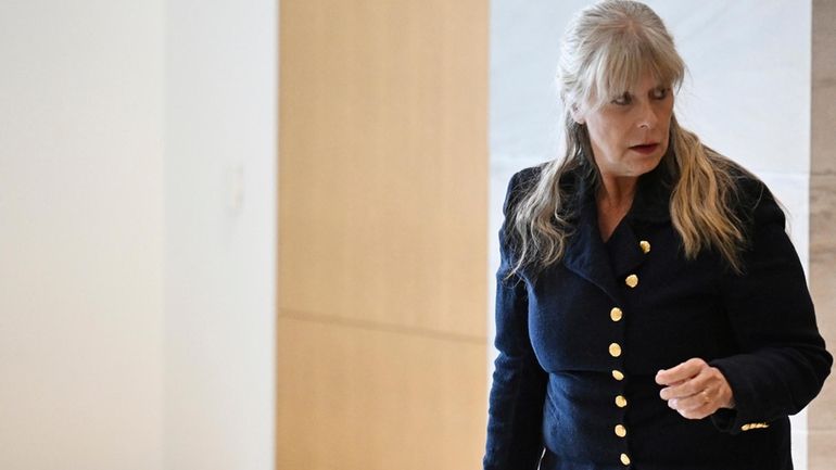 Linda Stanley leaves the Lindsey-Flanigan Courthouse after the first day...