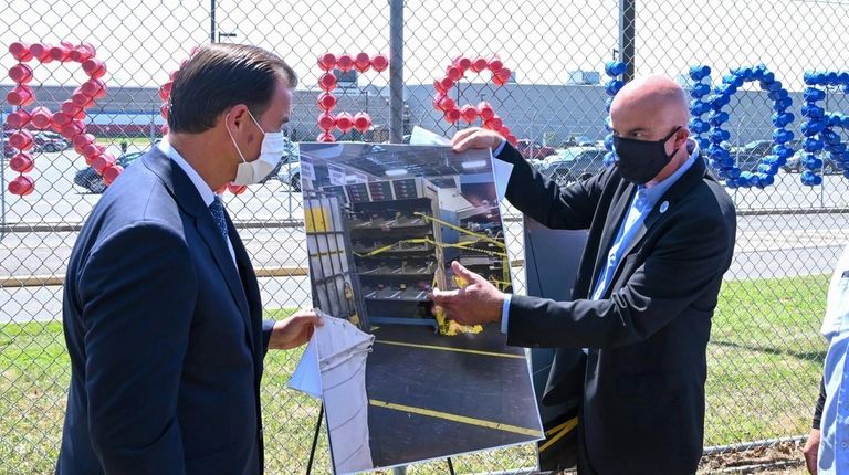 Rep. Tom Suozzi (D-Glen Cove), left, looks at a photograph...