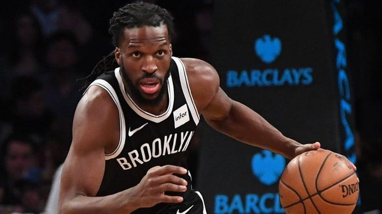 Nets forward DeMarre Carroll dribbles the ball up court against...