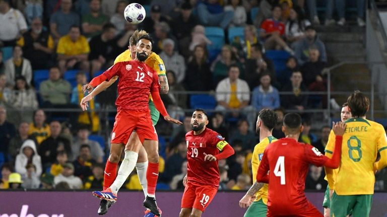 Bahrain's Mahdi Abduljabbar Mahdi Darwish Hasan, front left, competes with...