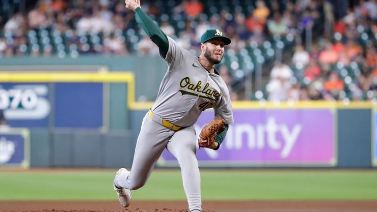 Oakland Athletics starting pitcher Mitch Spence throws against the Houston...