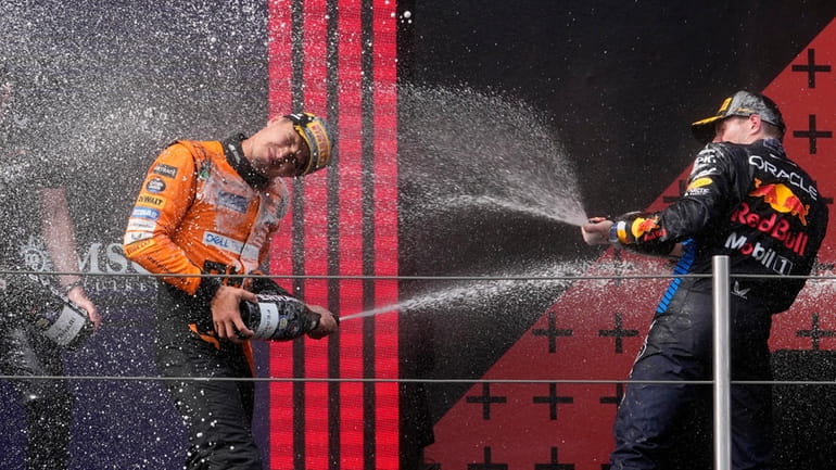 second placed McLaren driver Lando Norris of Britain, left, celebrates...