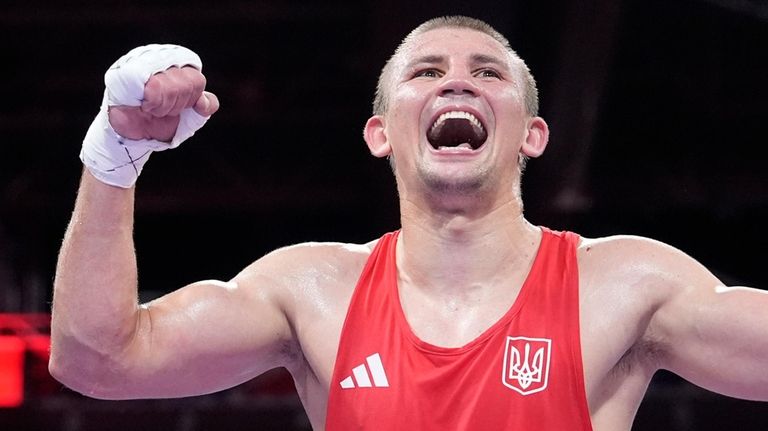 Ukraine's Oleksandr Khyzhniak celebrates after defeating Cuba's Arlen Lopez in...