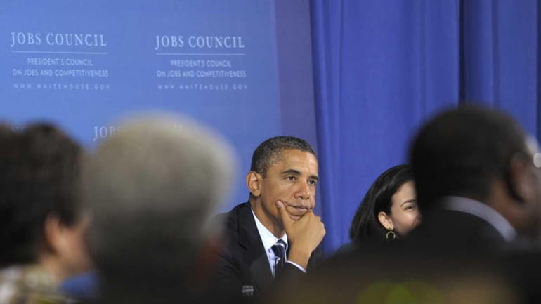 President Barack Obama listens to remarks during a meeting of...