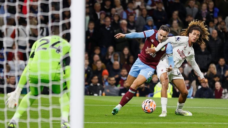 Burnley's Josh Brownhill, center, and Manchester United's Hannibal Mejbri battle...