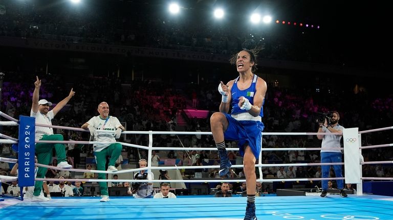 Algeria's Imane Khelif celebrates after defeating Thailand's Janjaem Suwannapheng in...