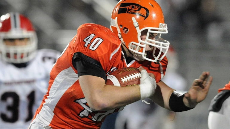 Carey's Conor Colasurdo carries the ball during the third quarter...