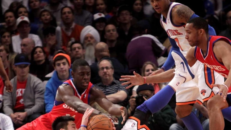 New York Knicks' Jeremy Lin, bottom, fights for a loose...