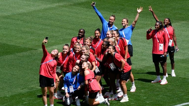 Canada's players pose for photos on the pitch at Geoffroy-Guichard...