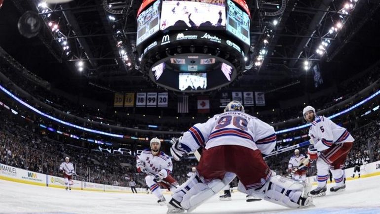 New York Rangers goalie Henrik Lundqvist, center, of Sweden, is...