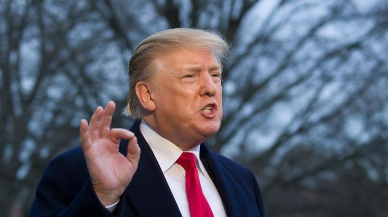 President Donald Trump speaks with the media after stepping off...