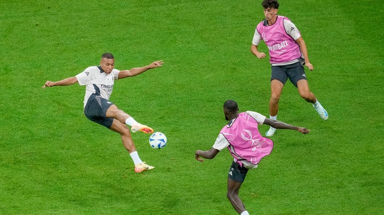 Real Madrid's Kylian Mbappe, left, takes part in a training...