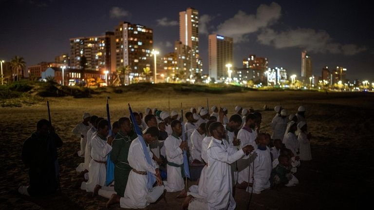 Worshippers of Intokozo Yamakrestu Church in Christ pray as they...