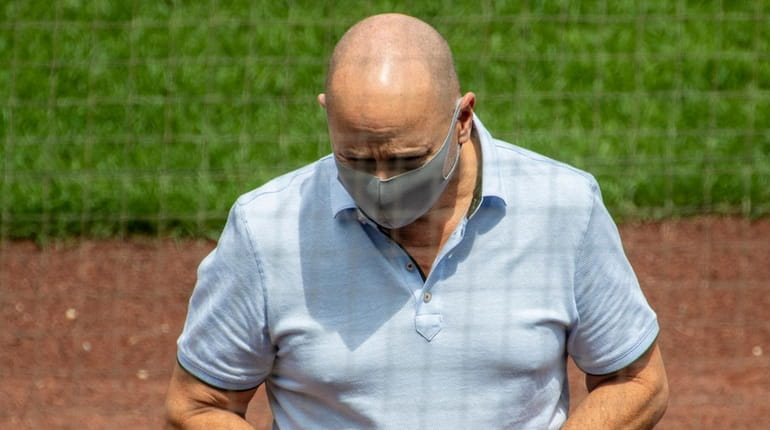 Yankees GM Brian Cashman sports a mask during practice at...