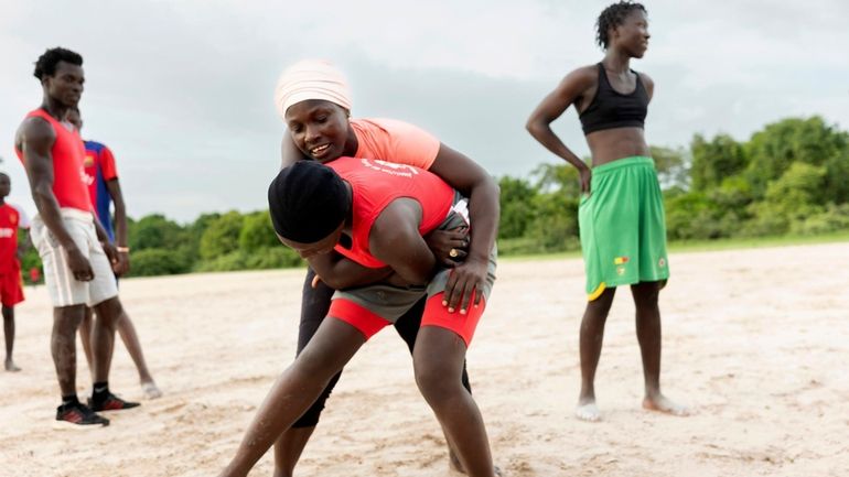 Coach Isabelle Sambou, 43 years old, rear, two-time Olympian and...