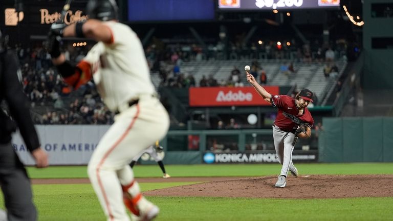 Arizona Diamondbacks pitcher Zac Gallen, right, pitches to San Francisco...