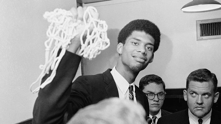 Lew Alcindor, later known as Kareem Abdul-Jabbar, still carrying part...