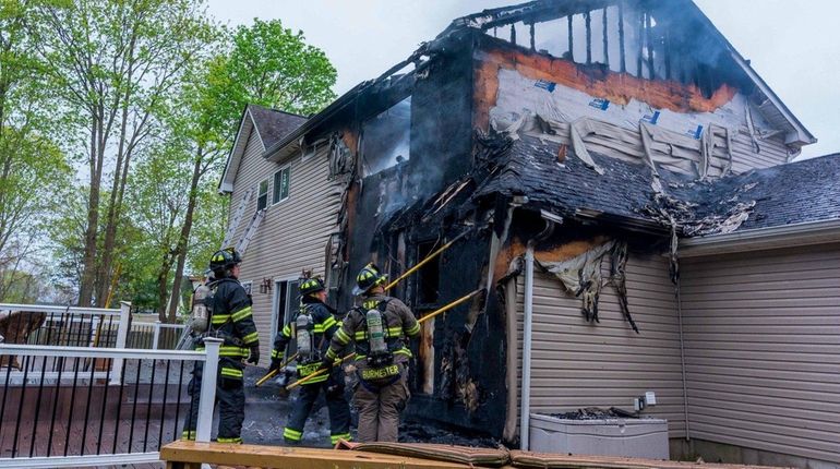 Firefighters at the scene of a house fire on Bernstein...