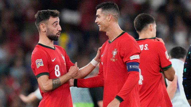 Portugal's Cristiano Ronaldo, centre, celebrates with Bruno Fernandes after the...