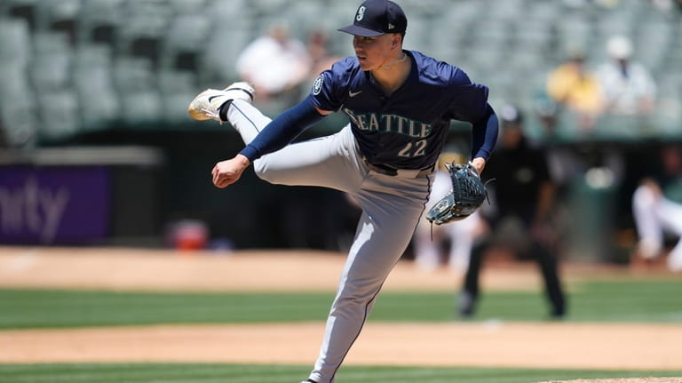 Seattle Mariners pitcher Bryan Woo works against the Oakland Athletics...