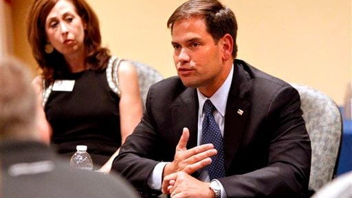 Sen. Marco Rubio, R-Fla., talks with business leaders during a...