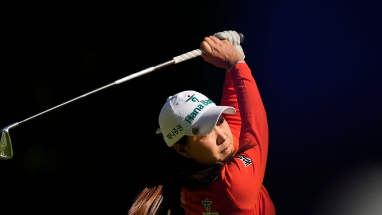Minjee Lee, of Australia, watches her shot after hitting on...