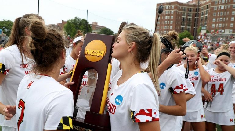 Members of the Maryland Terrapins celebrate following their 12-10 win...