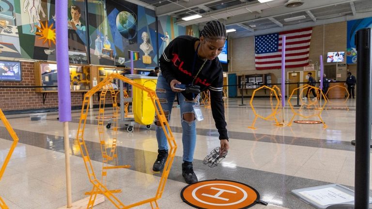 Baldwin High senior Nichealla Fong-Woo practices flying a drone at...