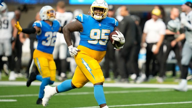 Los Angeles Chargers defensive tackle Poona Ford (95) celebrates after...