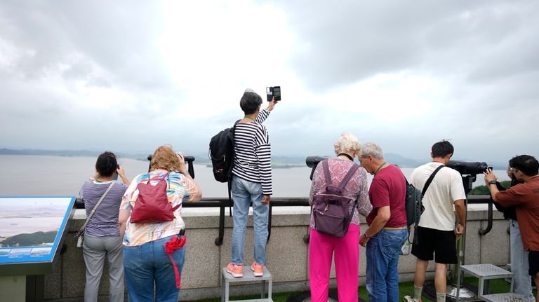 Visitors look at the North Korean side from the unification...