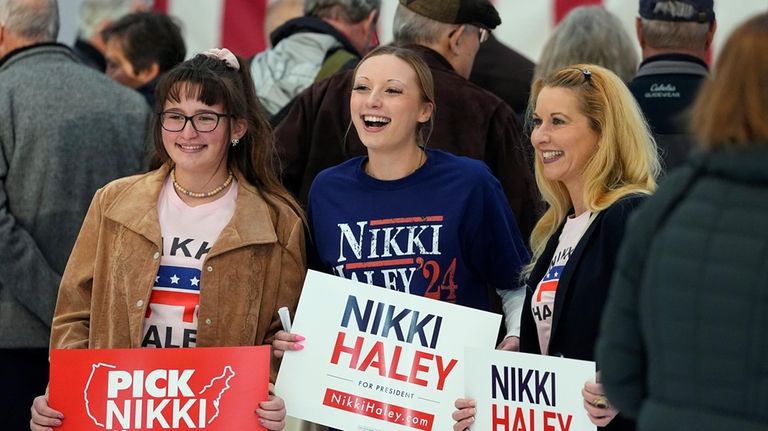 From left, sisters Peyton and Luch Schmit join their mother,...