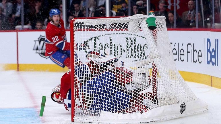 Chris Kreider of the Rangers crashes into Carey Price of...