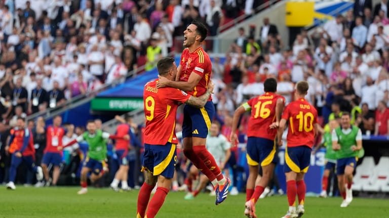 Spain's players celebrate at the end of a quarter final...