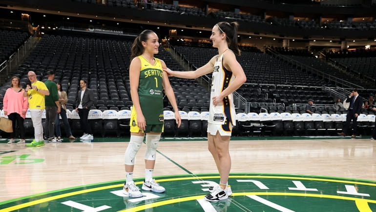 Seattle Storm guard Nika Muhl, left, and Indiana Fever guard...