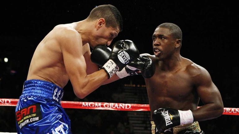 Andre Berto, right, lands a punch that sends Freddy Hernandez,...