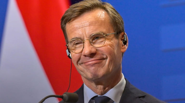 Sweden's Prime Minister Ulf Kristersson smiles during a news conference...