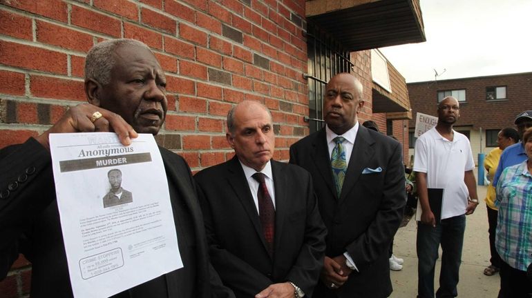 Pastor William H. Fuller, along with community members and religious...