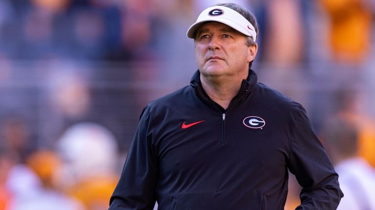 Georgia head coach Kirby Smart watches his players warm up...