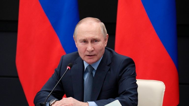 Russian President Vladimir Putin speaks during a meeting with the...