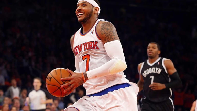 Carmelo Anthony #7 of the New York Knicks smiles enroute...