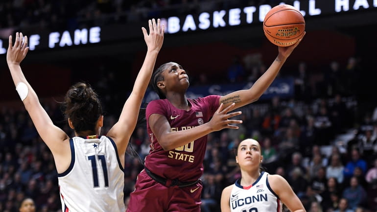 Florida State's Ta'niya Latson goes up for a basket as...