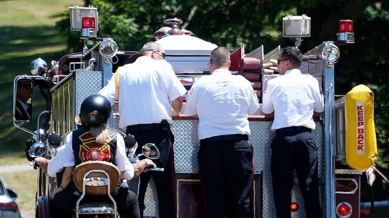 A Saxonburg, Pa., fire truck carrying the coffin of Cory Comperatore,...