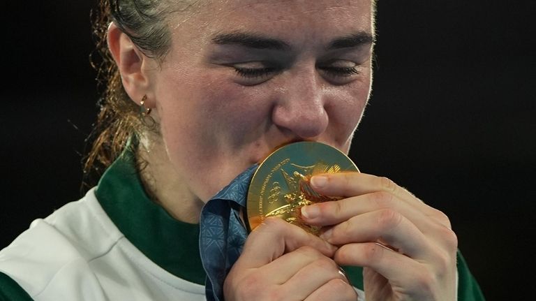 Gold medalist Ireland's Kellie Harrington poses on the podium with...